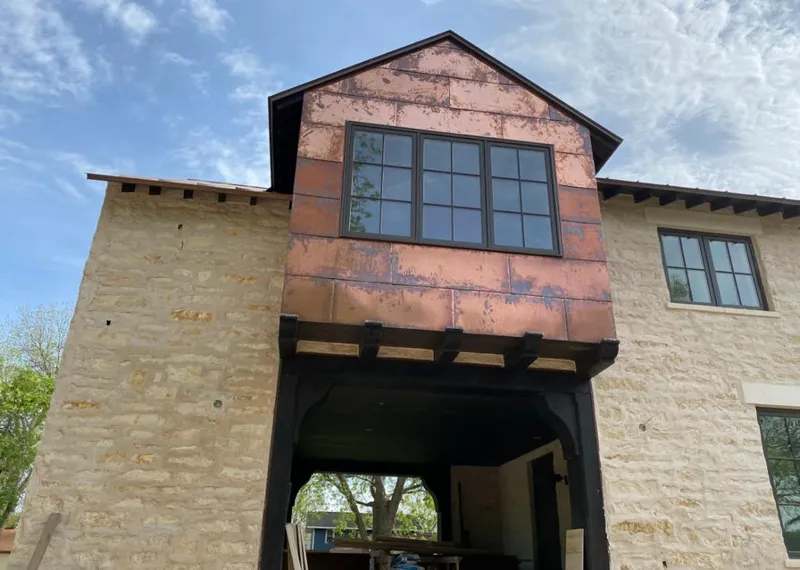 Copper metal panel facade on a stone building for Skylight Installation in Elkridge