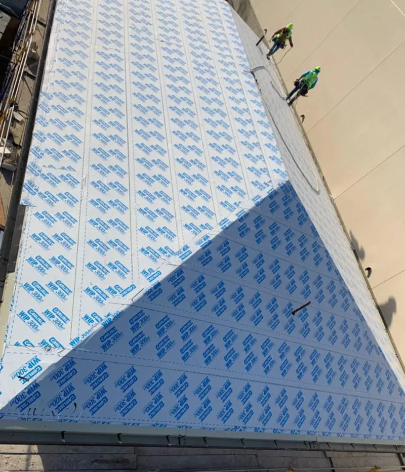 Professional roofers installing underlayment on a metal roof in Elkridge